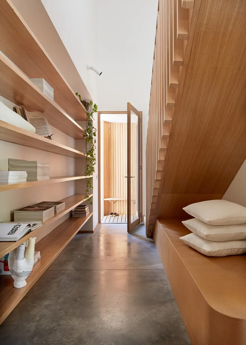 Veneered shelving, stair and joinery in a finished interior